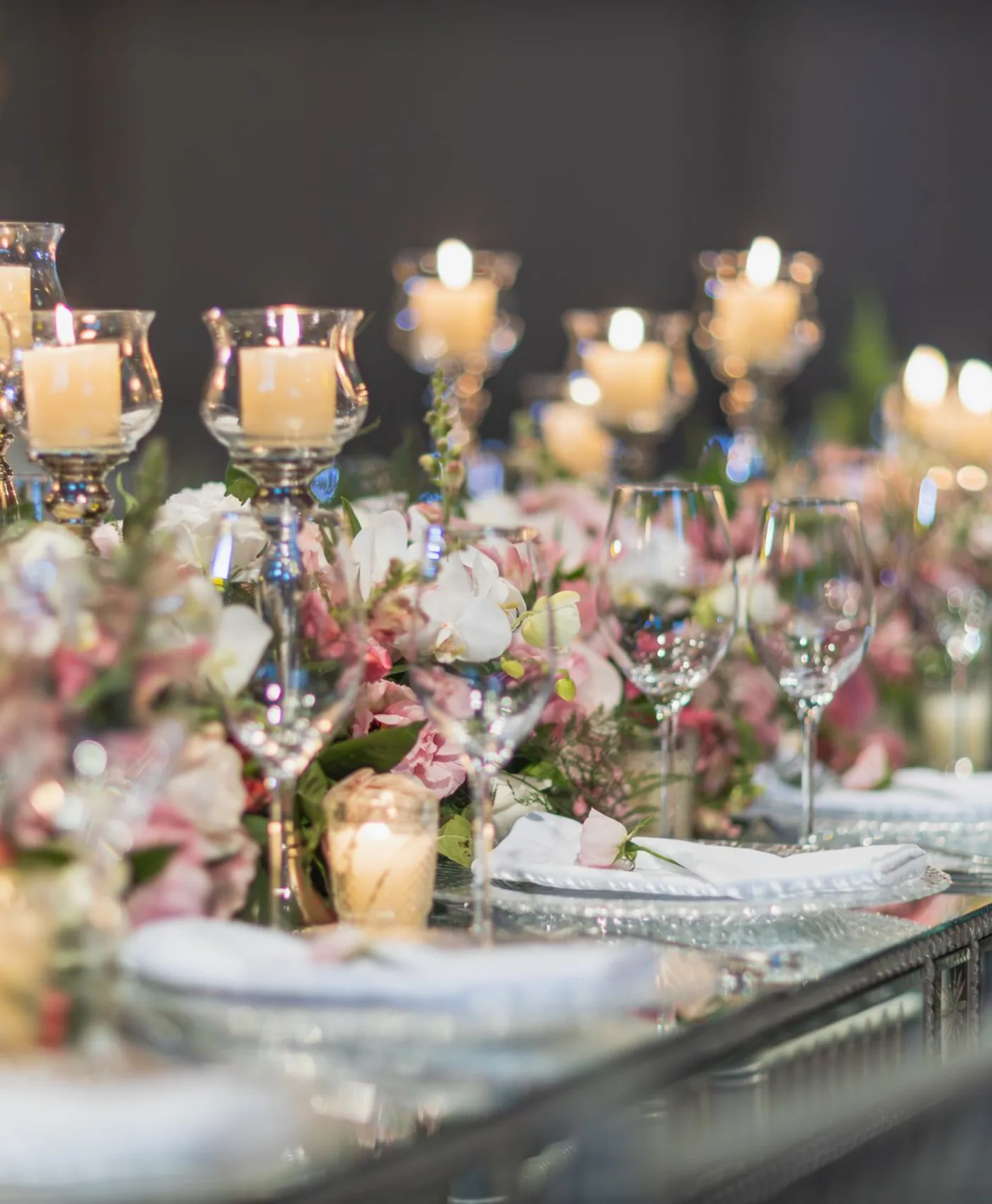 Intimate candlelit tablescape with pale flowers